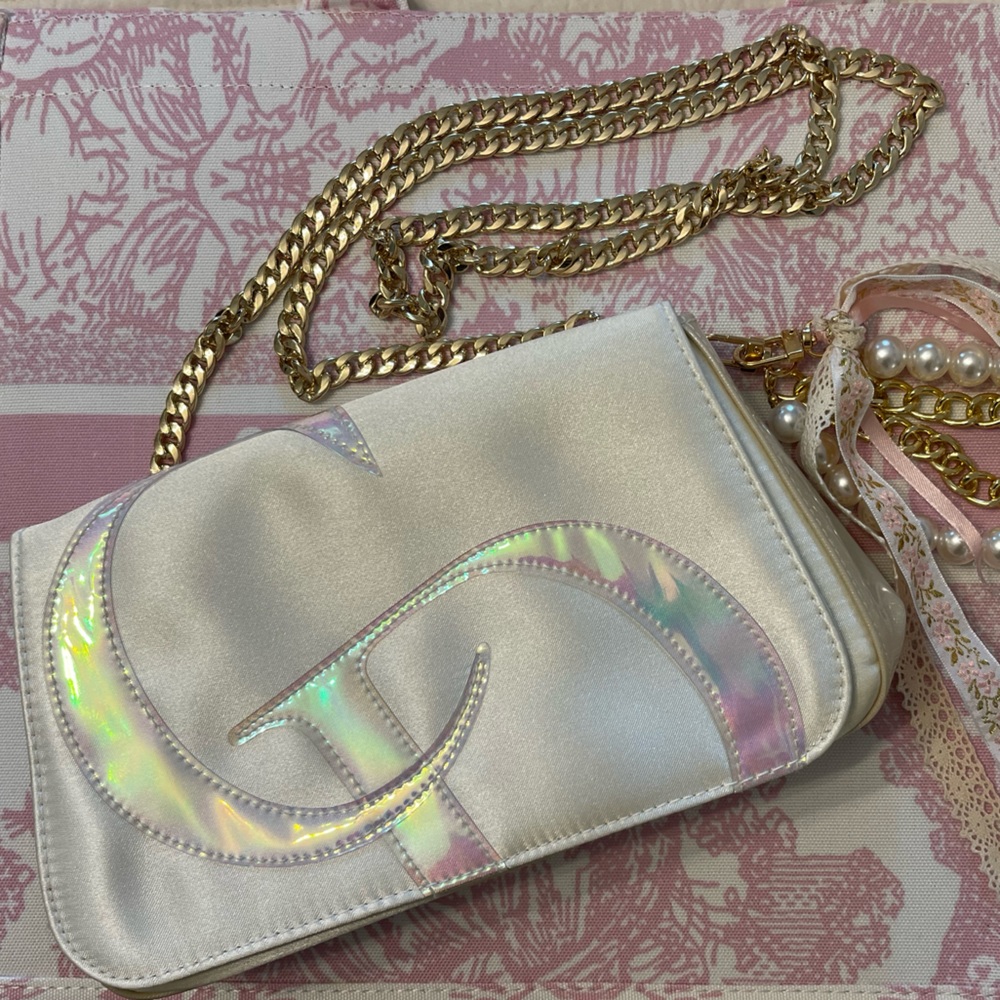 Dior crossbody/wristlet/clutch satin purse. Iridescent “CD” large logo on front.